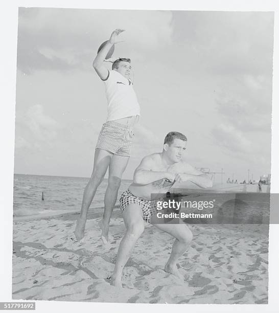 Duke University football players warm up on the sands at Miami Beach in preparation for their Orange Bowl game with Nebraska New Year's Day. They are...