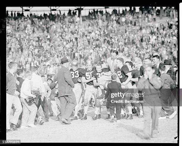 Navy coach Eddie Erdelatz is carried off the field on the shoulders of his victory team after the Middies sand the University of Mississippi in the...