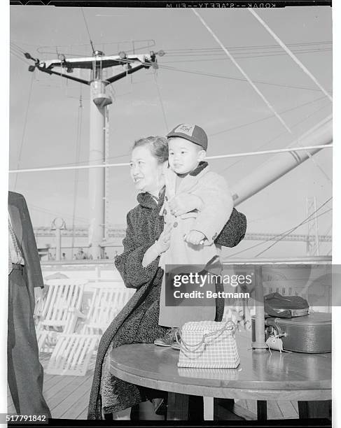 Two year old Andrew Gee, born a British subject in Hong Kong, is held by Mrs. Teng Gee, the Chinese American housewife from Berkeley, Calif. Who had...