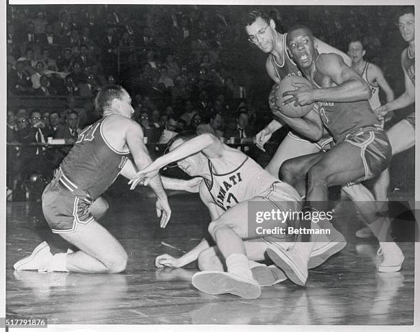 All-American Si Green of Duquesne stops short with the ball as teammate comes up for assistance after a scramble in the second half of the National...