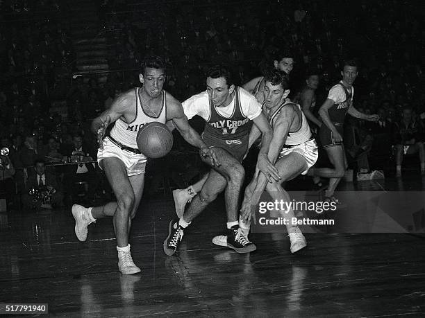 Holy Cross vs. Michigan: Bob Cousy Between Michigan's Bob Harrison and Mack Suprunowicsz