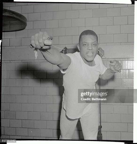 Looking more like a pugilist than the baseball great he is, Willie Mays of San Francisco Giants gets in a strenuous workout here at the Harlem YMCA....