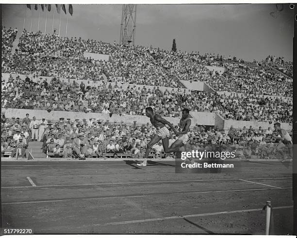 Ray Norton, of the U.S.A. Receives the baton form teammate Frank Budd during the heat men's 4x100 meters relay, which the American team won.