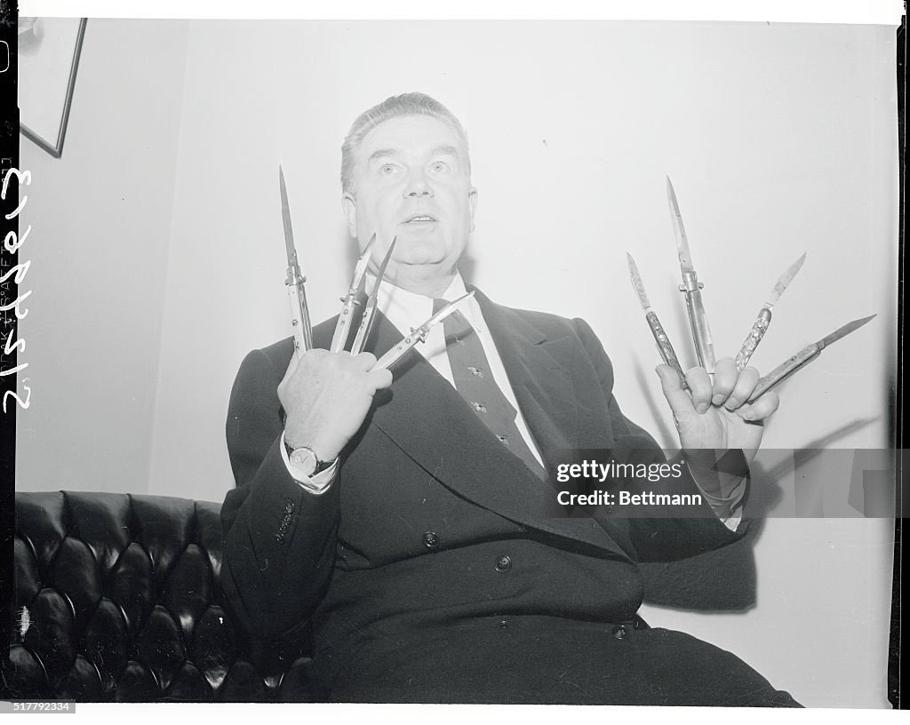 James Delaney Holding Switchblade Knives