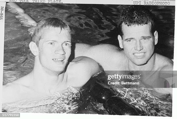 Swim stars Mike Troy and Dave Gillanders smile in the water after they finished first and third, respectively, in the men's 200-meter butterfly...