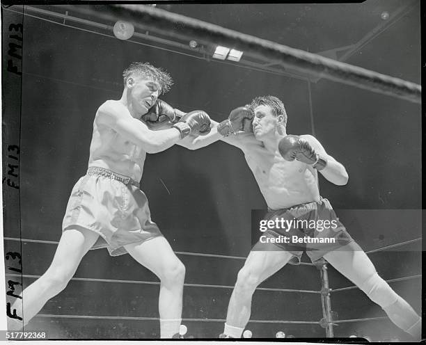 New York: Here's Leather In Your face. Al Andrews, Superior, Wisconsin, middleweight, seems to be resting dreamily on the glove of the unseen Gustav...