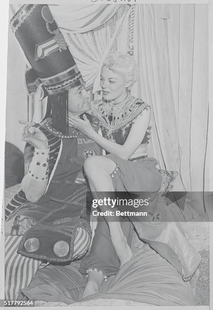 Hollywood, California: Actress Sheree North with cigar smoking comedian Red Skelton in an Egyptian comedy skit on Red's CBS television show.