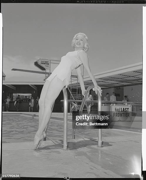 The photographer forgot to get the name of the new style bathing suit that Miss Mamie Van Doren, Universal star, is modeling here at the Hotel Last...