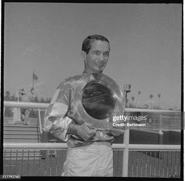 Bill Shoemaker clutches his trophy after he rode his 4000th winner in the third race at Hollywood Park here today.