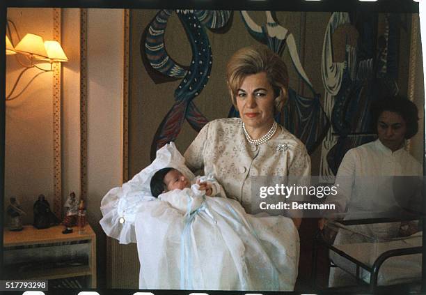 The mother of Empress Farah Diba holds Princess Farahnaz, the new daughter of the Empress and Shah Mohammed Reza Pahlavi.