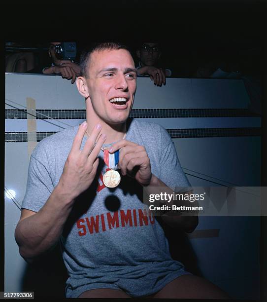 Chet Jastremski holds the gold medal he received after winning the 200 meter breaststroke with a time of 2:90. Jastremski went on to win the bronze...