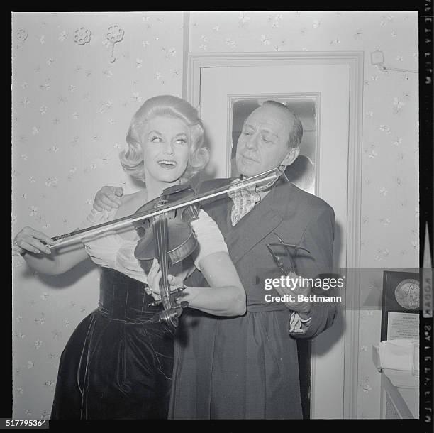 Fiddling Around. New York: Comedian Jack Benny looks on as singer Jane Morgan tries to find out if good music can come out of Benny's violin. The...