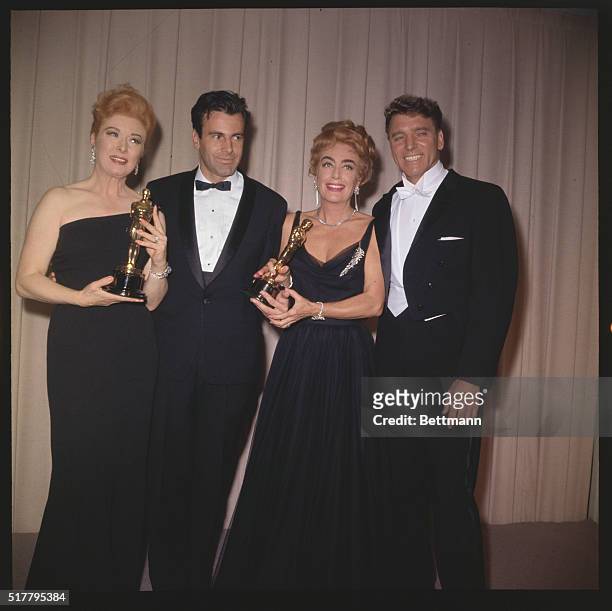 Greer Garson , Maximilian Schell , Joan Crawford , and Burt Lancaster pose with their Oscars at the Academy Awards.