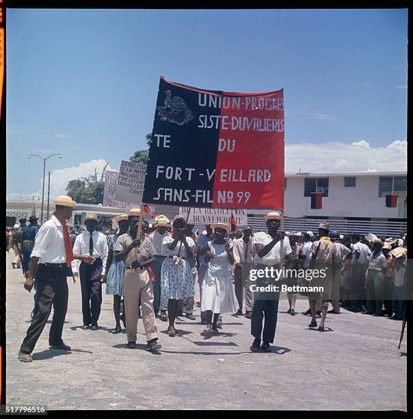 Port Au Prince: Workers/peasants hold up signs during pro President Francois Duvalier political rally.