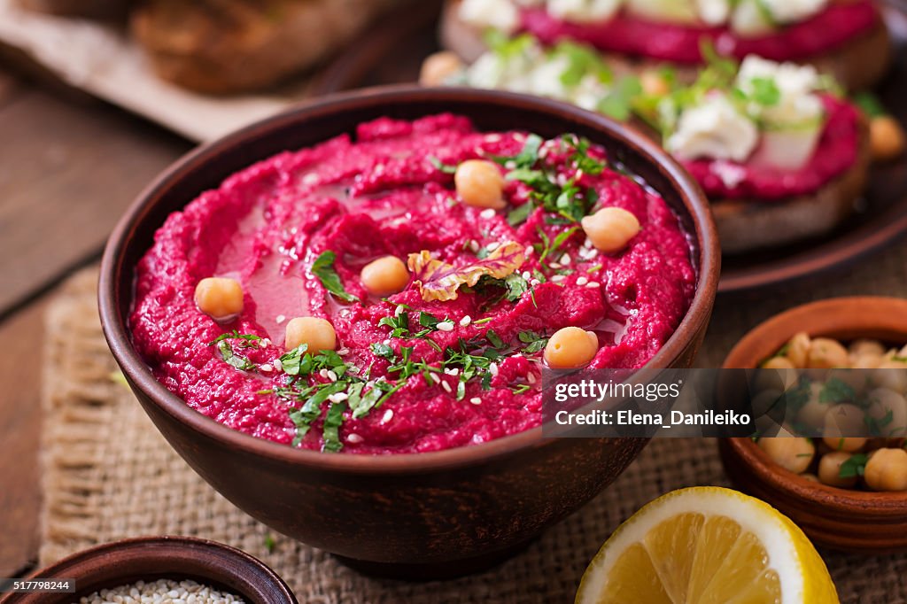 Roasted Beet Hummus with toast in a ceramic bowl
