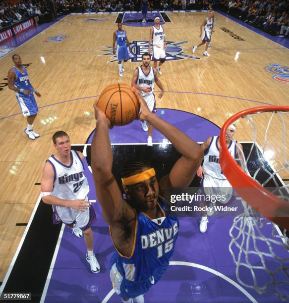 Carmelo Anthony of the Denver Nuggets goes for a dunk during a game against the Sacramento Kings at Arco Arena on November 14, 2004 in Sacramento,...