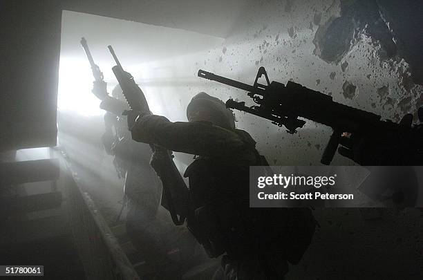 Stepping back into the battlefield, U.S. Marines of the Light Armored Reconnaissance company of 1st Battalion 3rd Marines, clear houses at the site...