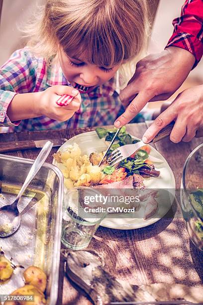 eating roast beef with potatoes and root vegetables - family dinner steak stock pictures, royalty-free photos & images
