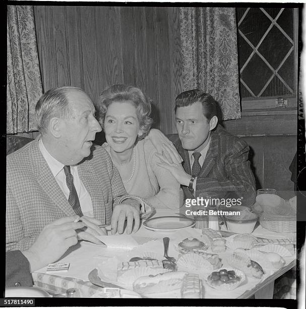 Maureen O'Sullivan flashes her lovely Irish smile while listening to Paul Ford at a New York restaurant. At right is Orson Bean. The three appear in...