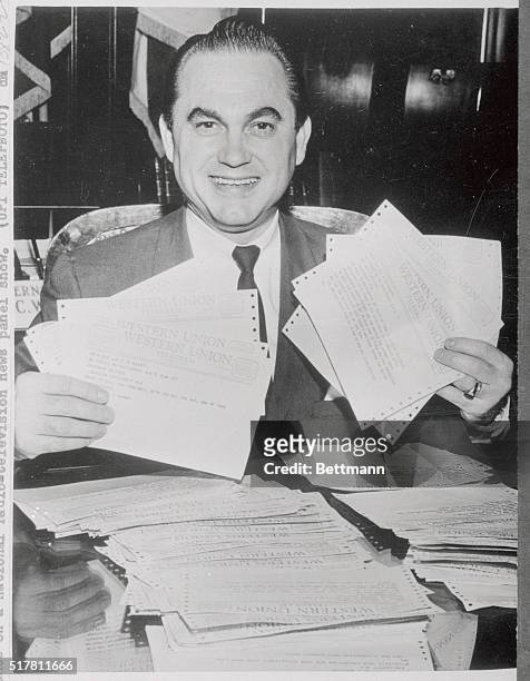 Governor George Wallace grins with approval over the telegrams flooding his office in support of his fight to prevent integration of the University...