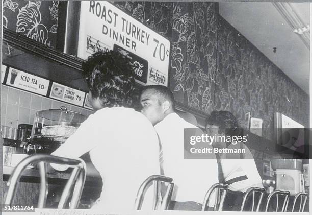 Jackson, Mississippi: Three Negro sit-ins sit peacefully at a Jackson, Mississippi lunch counter minutes before violence erupted. Memphis Norman was...