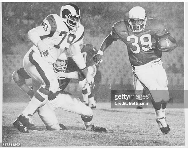 Coy Bacon L. A. Rams moves in on Cid Edwards of St. Louis.