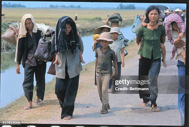 Getting a lift...Arriving here from Pleiku, this truck is piled to the top and then some as refugees continue to flee advancing Communist forces in...