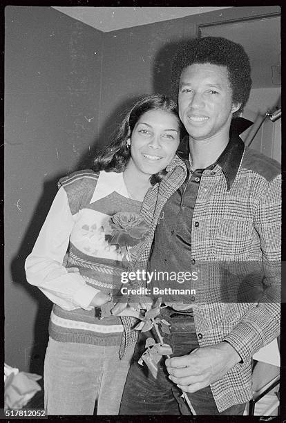 Tennis champion Arthur Ashe and his fiancee, Jeanne Marie Moutoussamy share a tender moment at her apartment here February 16, following reports that...