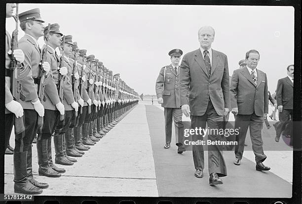 Belgrade: President Gerald Ford and President Tito of Yugoslavia review honor guards after Ford's arrival at Belgrade Airport for a 24 hour state...