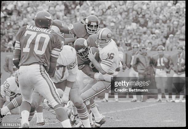 Bloomington, Minn.: San Francisco 49ers quarterback Norm Snead isn't going anywhere but down to the ground as he is grabbed behind the line of...