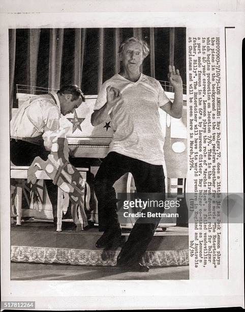Los Angeles, CA: Ray Bolger does a little jig as Jack Lemmon plays the piano in the background as the two perform together for the first day of...