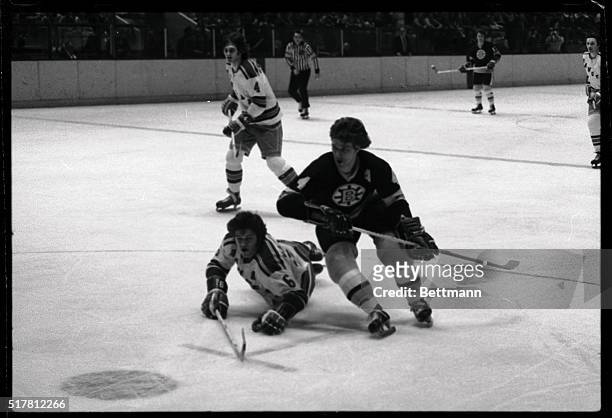 Boston Bruins' Bobby Orr skates around downed Gilles Marotte, of the New York Rangers.