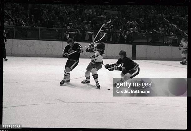 Sticks are high as New York Rangers' Ron Greschner battles for the puck against Boston Bruins' Gregg Sheppard and Bobby Orr . The Rangers won the NHL...