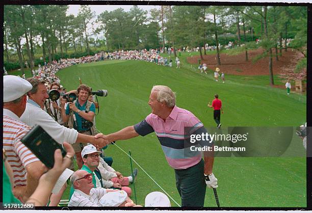 Augustus, Ga.: Arnold Palmer who will be playing in his 35th Masters when play begins April 6 shakes hands with members of his "army" during the par...