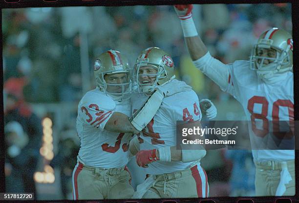 Chicago: San Francisco 49ers fullback Roger Craig and teammate Tom Rathman celebrate after Craig scored the 4th 49ers touchdown against the Bears in...
