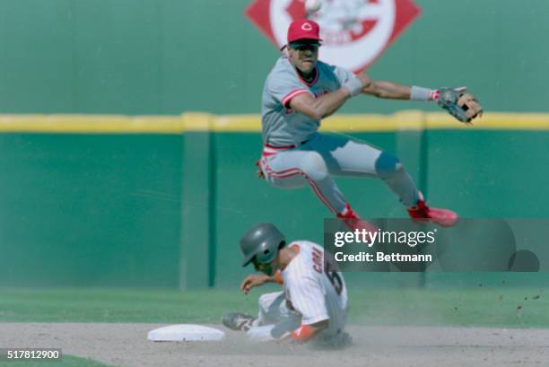 San Diego: Cincinnati Reds' Barry Larkin flys over San Diego Padres' Joey Cora in a double-play attempt in the 7th inning. The Reds' won 9-2,...