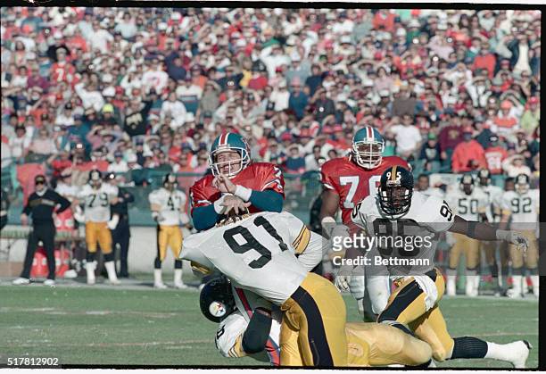 Denver: Denver quarterback John Elway moves back to pass before being brushed by Pittsburgh linebacker Jerrol Williams during the opening of the...