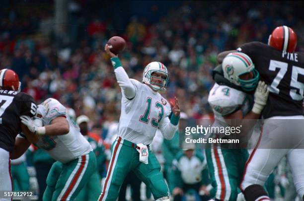 Dan Marino, quarterback for the Miami Dolphins is put under heavy pressure by Carl Banks of the New York Giants late in the fourth quarter at Giants...