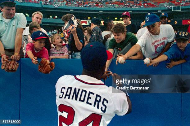 Braves' left fielder Deion Sanders is very popular with the fans as he sings autographs prior to the rain-delayed season opener 4/9. Sanders is the...