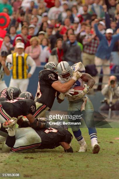 Cowboys' running back Emmitt Smith is brought down in his own end zone by Falcons Tim Green for an Atlanta safety and two pionts early in the 3rd...