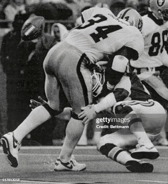 Raiders Bo Jackson carries the ball up the middle for seven yards before the Kansas City Chiefs Deron Cherry causes him to fumble.