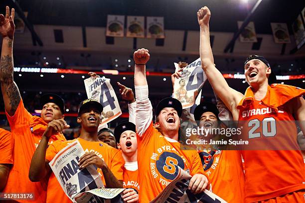 The Syracuse Orange celebrate their 68 to 62 win over the Virginia Cavaliers with teammates during the 2016 NCAA Men's Basketball Tournament Midwest...