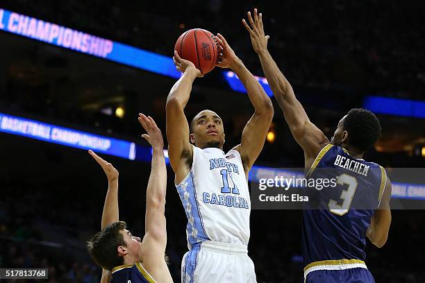 Brice Johnson of the North Carolina Tar Heels shoots the ball in the first half against Steve Vasturia and V.J. Beachem of the Notre Dame Fighting...