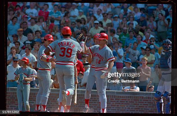 Reds' Dave Parker is congratulated by Pete Rose after hitting a grand slam home run in the ninth inning of a game, 9/7. Rose went 0 for 4 in his...