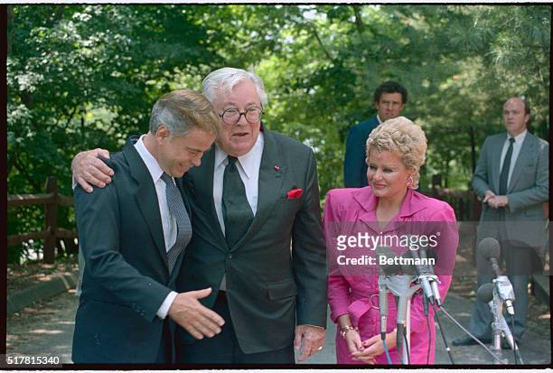 Tega Cay, South Carolina: Celebrity lawyer Melvin Belli puts his arm around Jim Bakker as Tammy Faye looks on just prior to a news conference outside...
