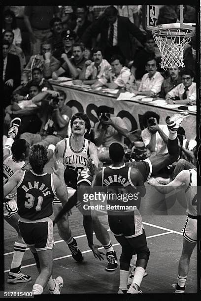 Celtics guard Danny Ainge hits the floor trying to draw an offensive foul call as Laker guard Magic Johnson drives past him in 1st quarter action.