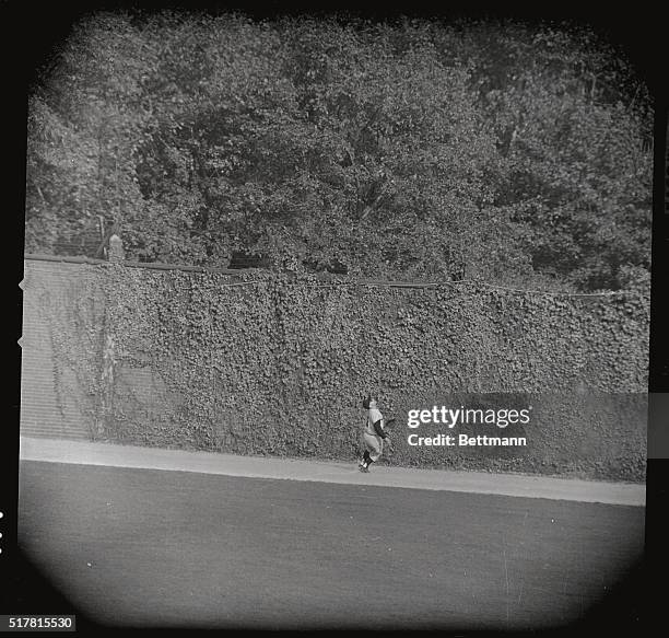 Yankee center fielder Yogi Berra watches Pirate Bill Mazerosk's homer go over the wall and win the series for the Pirates.