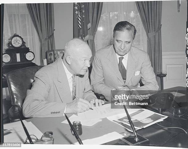 Washington, D.C.: Senator Prescott Bush looks on as President Eisenhower approves his bill which provides for a survey of the East Coast of the U.S....