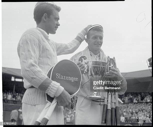 Defeated Rival Crowns Trabert Tennis King. Wimbledon, England: Good sportsmanship is displayed by Denmark's Kurt Nielsen as he crowns Tony Trabert of...