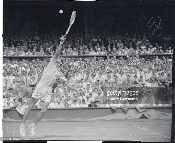 Skyscraper at Wimbledon. Wimbledon, England: S. Davidson of Sweden stretches his long, lean frame skyward to snare the ball during his fourth day...
